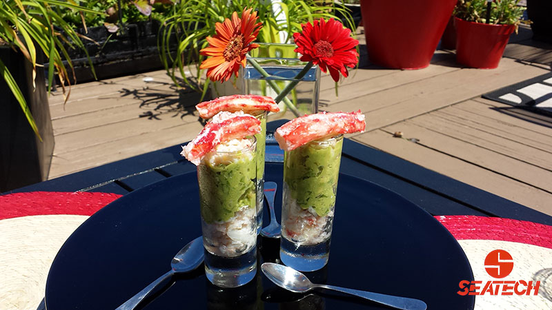 A photograph of Chilean king crab and avocado shooters.